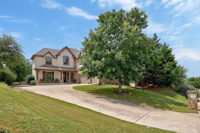 106 Tonkawa Trl W, Austin, TX 78738 - view of front facade featuring driveway, a garage, a front lawn, and stucco siding