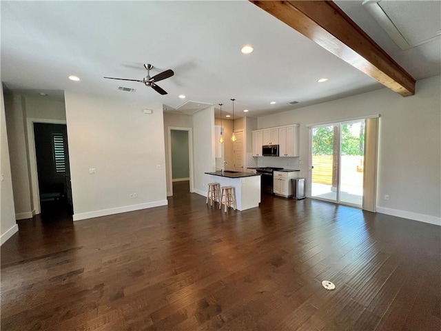 1126 Linden St Unit 2, Austin, TX 78702 - unfurnished living room with attic access, a ceiling fan, dark wood-style flooring, recessed lighting, and beamed ceiling