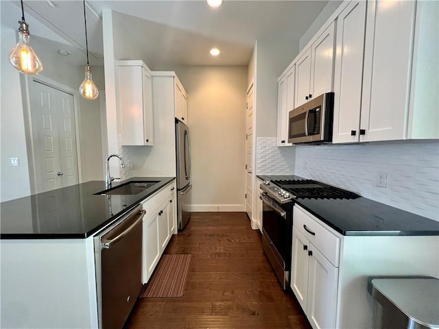 1126 Linden St Unit 2, Austin, TX 78702 - kitchen featuring stainless steel appliances, dark countertops, recessed lighting, dark wood finished floors, and a peninsula