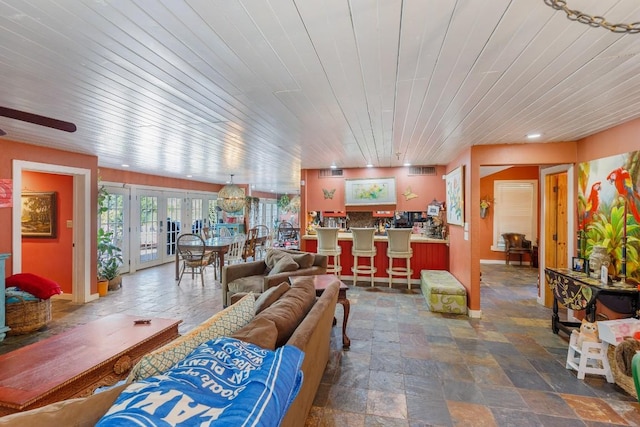 4842 W Fm 2147, Horseshoe Bay, TX 78657 - living room featuring stone finish flooring, wooden ceiling, a ceiling fan, and french doors
