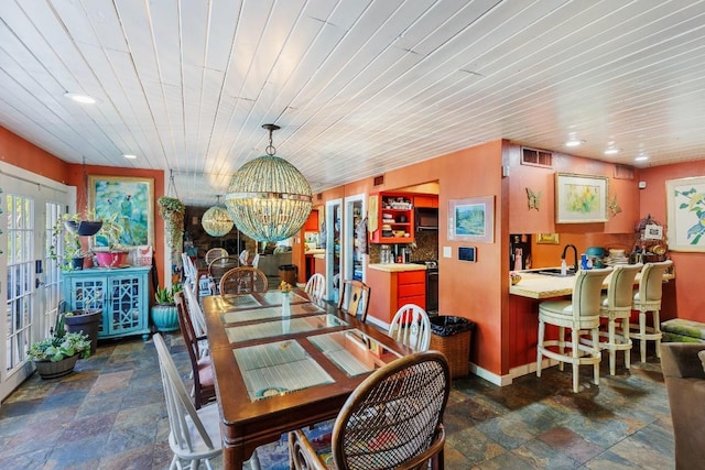 4842 W Fm 2147, Horseshoe Bay, TX 78657 - dining space with stone finish floors, a chandelier, recessed lighting, wooden ceiling, and french doors