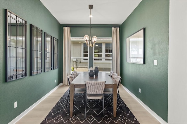 19512 Erna Dr, Pflugerville, TX 78660 - dining room with light wood finished floors, a chandelier, and a textured wall