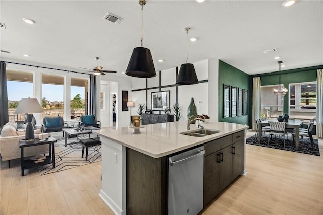 19512 Erna Dr, Pflugerville, TX 78660 - kitchen featuring dishwasher, open floor plan, light countertops, a kitchen island with sink, and plenty of natural light