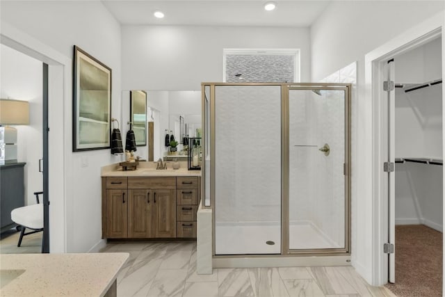 19512 Erna Dr, Pflugerville, TX 78660 - bathroom with vanity, a stall shower, a spacious closet, marble finish floors, and recessed lighting