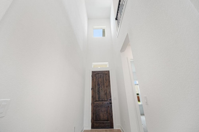 1601 Cardinal Ln, Round Rock, TX 78681 - corridor featuring wood finished floors and a towering ceiling