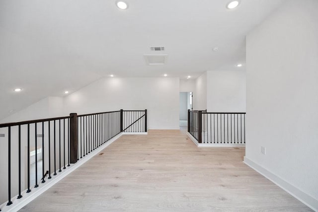 1601 Cardinal Ln, Round Rock, TX 78681 - hall with light wood-style floors, recessed lighting, an upstairs landing, and lofted ceiling