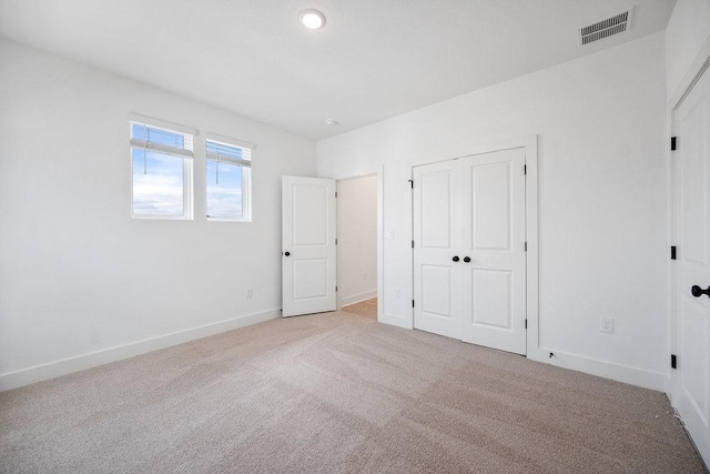 1601 Cardinal Ln, Round Rock, TX 78681 - unfurnished bedroom featuring light colored carpet, a closet, and recessed lighting