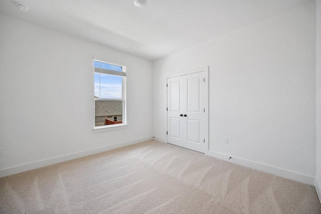 1601 Cardinal Ln, Round Rock, TX 78681 - unfurnished bedroom with light colored carpet and a closet