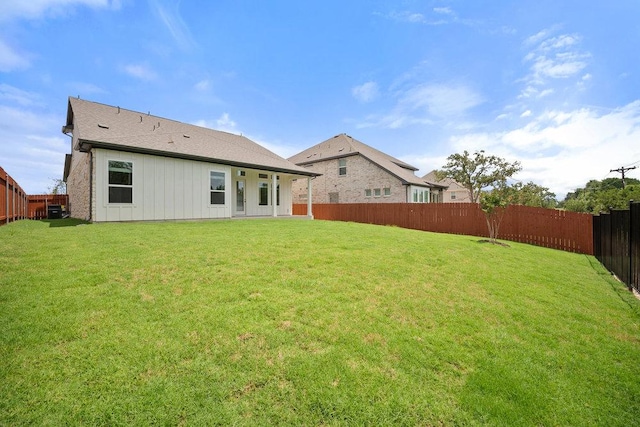 1601 Cardinal Ln, Round Rock, TX 78681 - rear view of house featuring a fenced backyard and board and batten siding