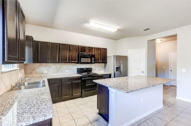 1710 Atlantica St, Cedar Park, TX 78613 - kitchen featuring black appliances, light tile patterned floors, decorative backsplash, dark brown cabinetry, and a center island