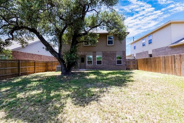 1710 Atlantica St, Cedar Park, TX 78613 - rear view of house with brick siding, a fenced backyard, and stucco siding