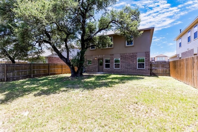 1710 Atlantica St, Cedar Park, TX 78613 - back of property featuring brick siding, a fenced backyard, and stucco siding