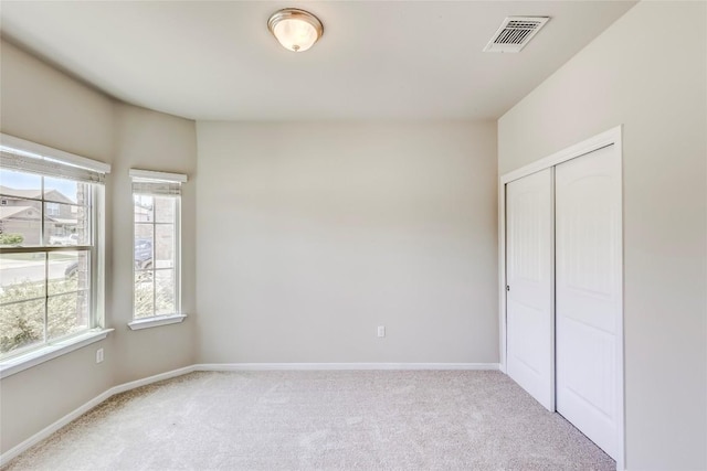 1710 Atlantica St, Cedar Park, TX 78613 - unfurnished bedroom with multiple windows, light carpet, and a closet
