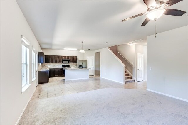 1710 Atlantica St, Cedar Park, TX 78613 - unfurnished living room with light colored carpet, stairway, a ceiling fan, and light tile patterned floors
