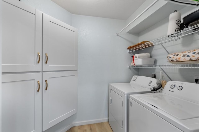 914 Flanagan Dr, Leander, TX 78641 - laundry room featuring cabinet space, washing machine and clothes dryer, and light wood finished floors