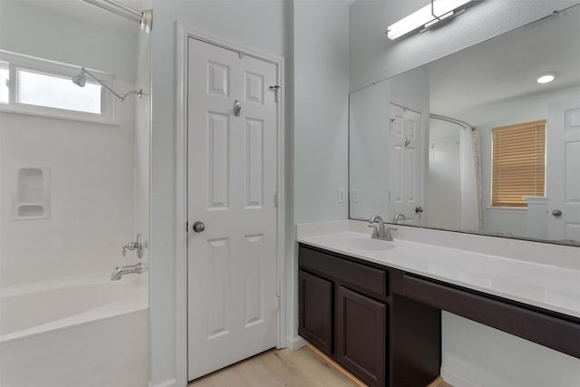 914 Flanagan Dr, Leander, TX 78641 - full bath with shower / bath combo with shower curtain, vanity, and wood finished floors