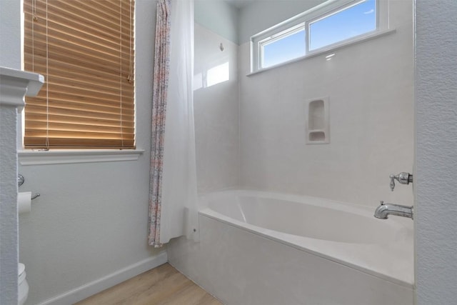914 Flanagan Dr, Leander, TX 78641 - full bathroom with wood finished floors and shower / bath combo