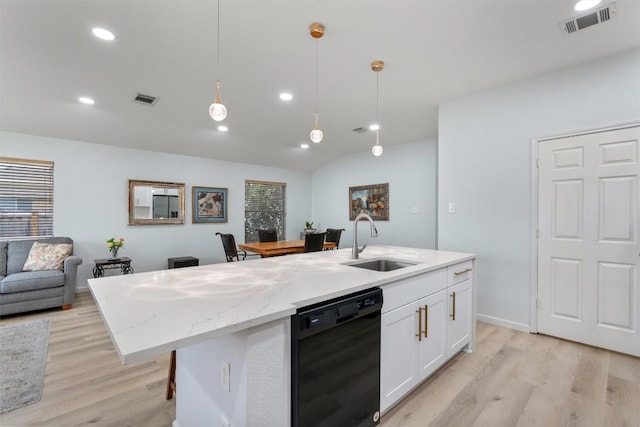 914 Flanagan Dr, Leander, TX 78641 - kitchen featuring dishwasher, light wood-style floors, white cabinetry, open floor plan, and recessed lighting