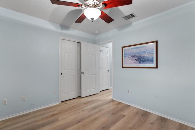 914 Flanagan Dr, Leander, TX 78641 - unfurnished bedroom with light wood-style flooring, ceiling fan, and a closet