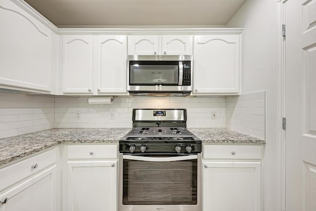 216 Cassandra Dr, Hutto, TX 78634 - kitchen with stainless steel appliances, white cabinetry, backsplash, and light stone counters