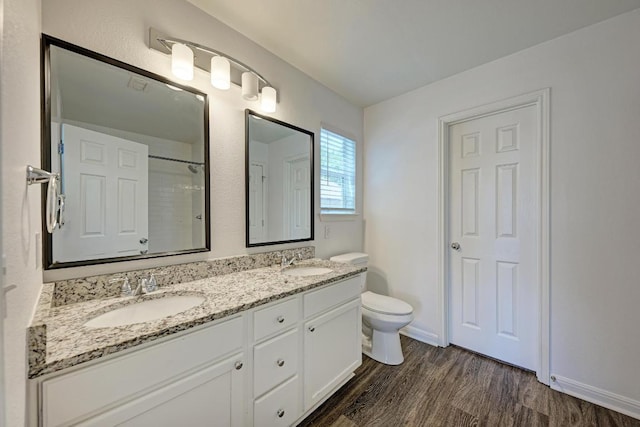 216 Cassandra Dr, Hutto, TX 78634 - full bathroom with double vanity, wood finished floors, and a shower