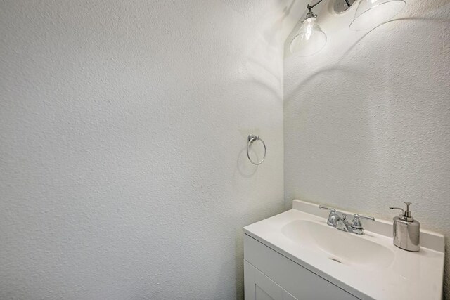 216 Cassandra Dr, Hutto, TX 78634 - bathroom with vanity and a textured wall
