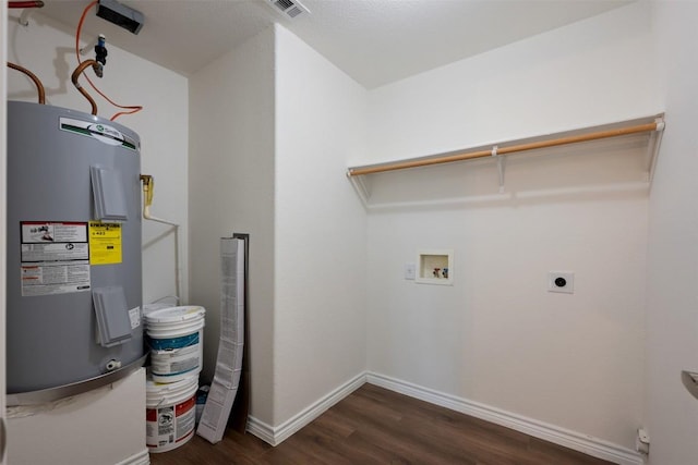 104 Live Oak Cir, Bertram, TX 78605 - washroom with hookup for an electric dryer, electric water heater, hookup for a washing machine, and dark wood-style flooring