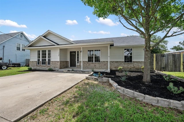 104 Live Oak Cir, Bertram, TX 78605 - view of front of property with brick siding, covered porch, and roof with shingles