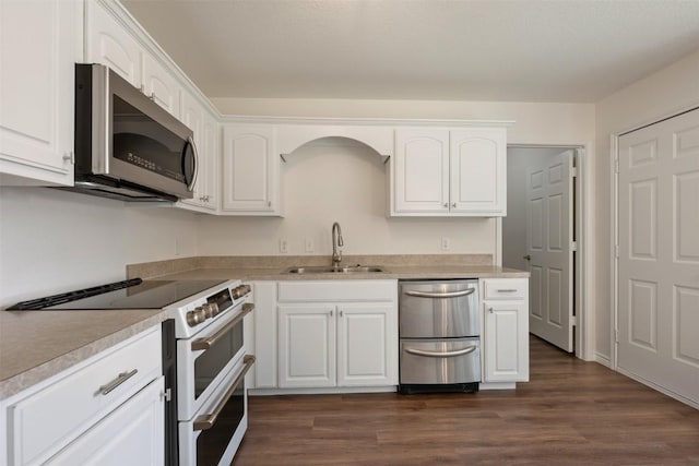 104 Live Oak Cir, Bertram, TX 78605 - kitchen featuring appliances with stainless steel finishes, white cabinetry, light countertops, and dark wood-style flooring