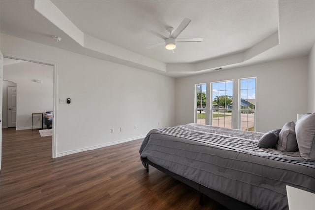 104 Live Oak Cir, Bertram, TX 78605 - bedroom with a tray ceiling, wood finished floors, and a ceiling fan