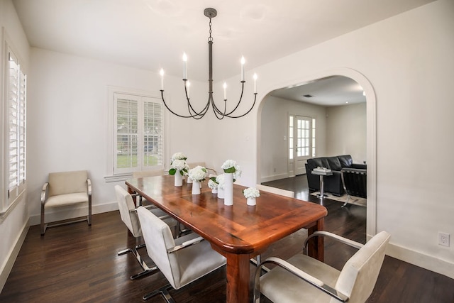 2908 Glenview Ave, Austin, TX 78703 - dining room with arched walkways, healthy amount of natural light, dark wood-type flooring, and a chandelier