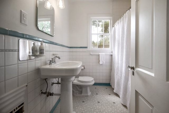 2908 Glenview Ave, Austin, TX 78703 - bathroom with wainscoting, tile walls, tile patterned floors, and a shower with shower curtain