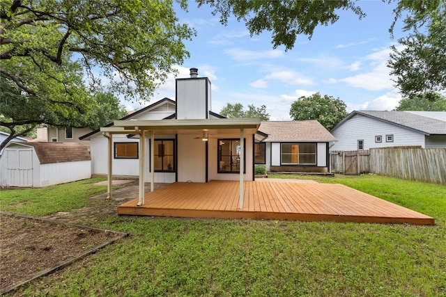 12416 Cassady Dr, Austin, TX 78727 - rear view of house with a fenced backyard, a chimney, a deck, a shed, and a ceiling fan