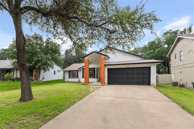 12416 Cassady Dr, Austin, TX 78727 - view of front facade featuring an attached garage, driveway, and a front yard