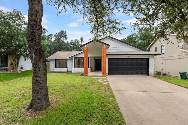 12416 Cassady Dr, Austin, TX 78727 - view of front of property featuring an attached garage, driveway, and a front lawn