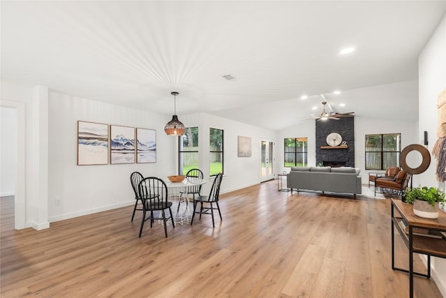 12416 Cassady Dr, Austin, TX 78727 - dining space with a stone fireplace, ceiling fan, light wood finished floors, lofted ceiling, and recessed lighting