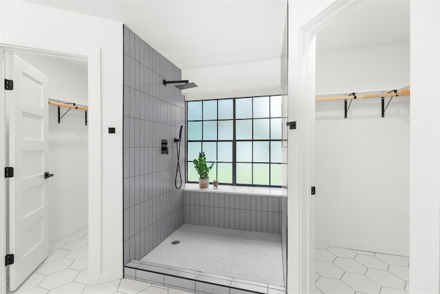 12416 Cassady Dr, Austin, TX 78727 - full bath featuring a tile shower, a walk in closet, and tile patterned floors