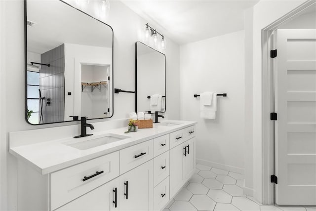 12416 Cassady Dr, Austin, TX 78727 - bathroom with double vanity, tile patterned flooring, a shower, and a walk in closet