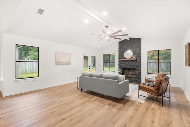12416 Cassady Dr, Austin, TX 78727 - living room featuring a fireplace, light wood-type flooring, a ceiling fan, and french doors