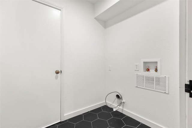 12416 Cassady Dr, Austin, TX 78727 - washroom featuring hookup for a washing machine, dark tile patterned floors, and hookup for a gas dryer