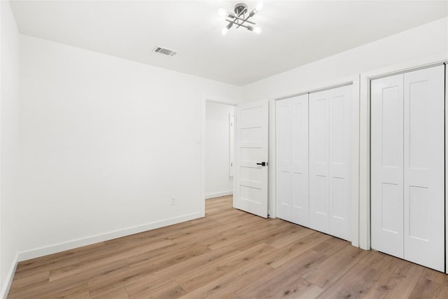 12416 Cassady Dr, Austin, TX 78727 - unfurnished bedroom with light wood finished floors and multiple closets