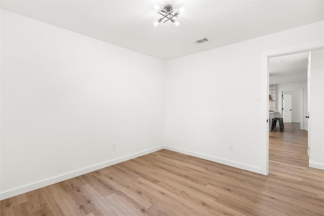12416 Cassady Dr, Austin, TX 78727 - empty room featuring light wood-style floors and a chandelier