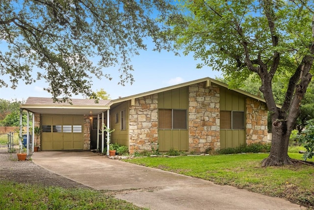 5201 Harvest Cir, Austin, TX 78745 - view of front of property featuring stone siding, driveway, a garage, and board and batten siding