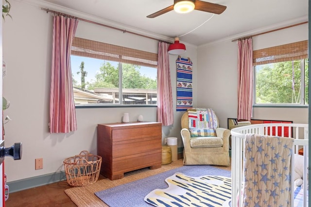 5201 Harvest Cir, Austin, TX 78745 - bedroom with ornamental molding, multiple windows, a nursery area, and a ceiling fan