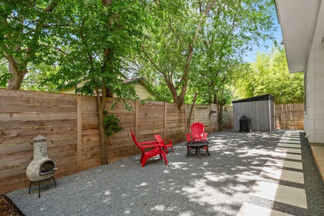 611 Gaylor St Unit 2, Austin, TX 78752 - fenced backyard featuring a fire pit, a shed, and a patio