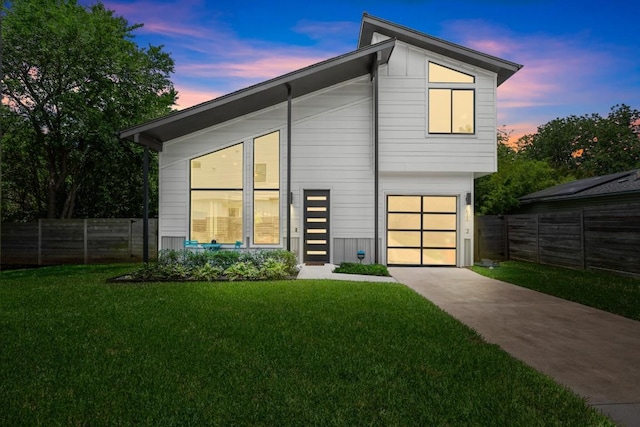 611 Gaylor St Unit 2, Austin, TX 78752 - back of house at dusk with concrete driveway and an attached garage