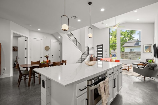 611 Gaylor St Unit 2, Austin, TX 78752 - kitchen with open floor plan, finished concrete flooring, stainless steel oven, a center island, and white cabinets