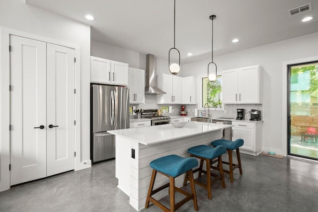 611 Gaylor St Unit 2, Austin, TX 78752 - kitchen featuring stainless steel appliances, wall chimney exhaust hood, finished concrete floors, a center island, and recessed lighting