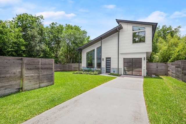 611 Gaylor St Unit 2, Austin, TX 78752 - rear view of house with concrete driveway and a garage