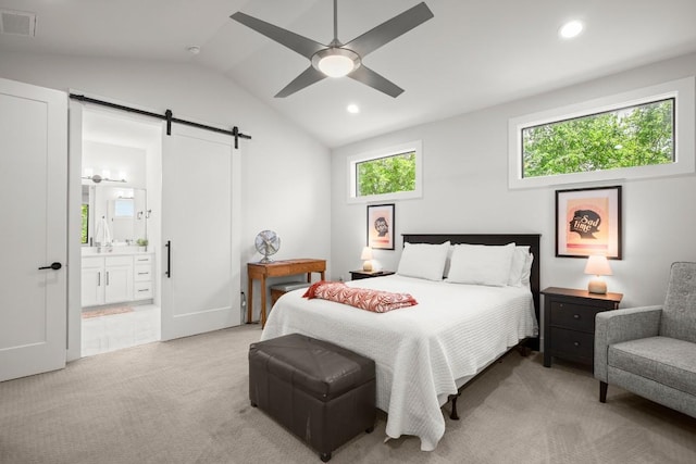 611 Gaylor St Unit 2, Austin, TX 78752 - bedroom featuring a barn door, light colored carpet, lofted ceiling, ensuite bath, and recessed lighting